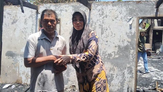 Kepala Puskesmas Embo, Murniati serahkan bantuan korban kebakaran. 