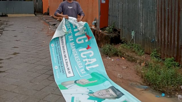 Relawan Deng Ical mulai menurunkan sendiri APK di Jl Toa Daeng, Manggala, Minggu (11/2). 