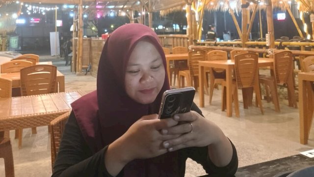 Riska saat menonton konten di TikTok menggunakan jaringan Indosat. (Foto: Gita/HN)
