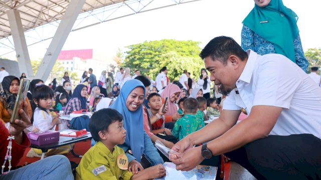 Pjs Wali Kota Makassar, Andi Arwin Azis, berbincang hangat dengan salah satu peserta yang mengikuti kegiatan Gerakan Makan Telur dan Lomba Mewarnai di Lapangan Karebosi, Rabu (09/10/2024).