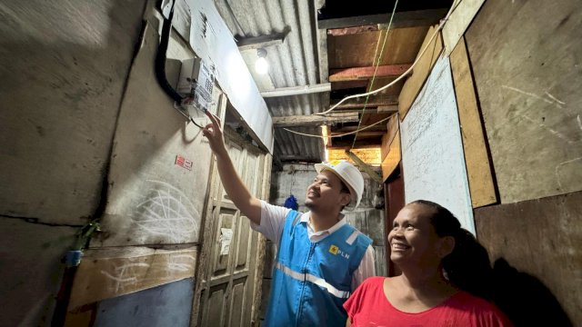 Umi (kanan), salah satu warga Jalan Rela, Kelurahan Menteng Atas, Kecamatan Setia Budi, Jakarta Selatan tampak bahagia dengan kehadiran listrik yang disambung oleh petugas, Foto: Dok PLN.